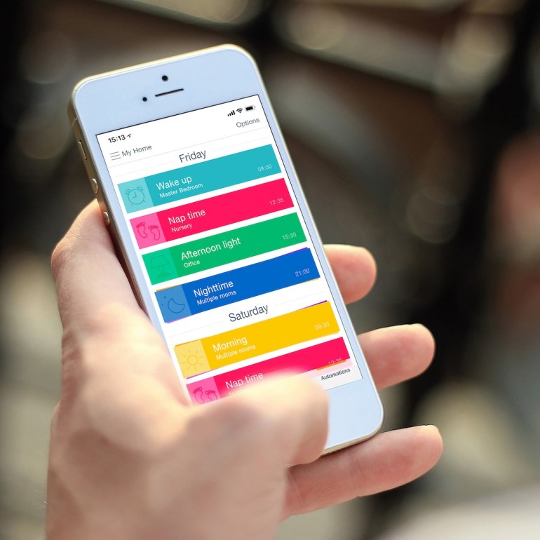 User controlling Luxaflex PowerView blinds using a mobile app with automated schedules for light and privacy management.